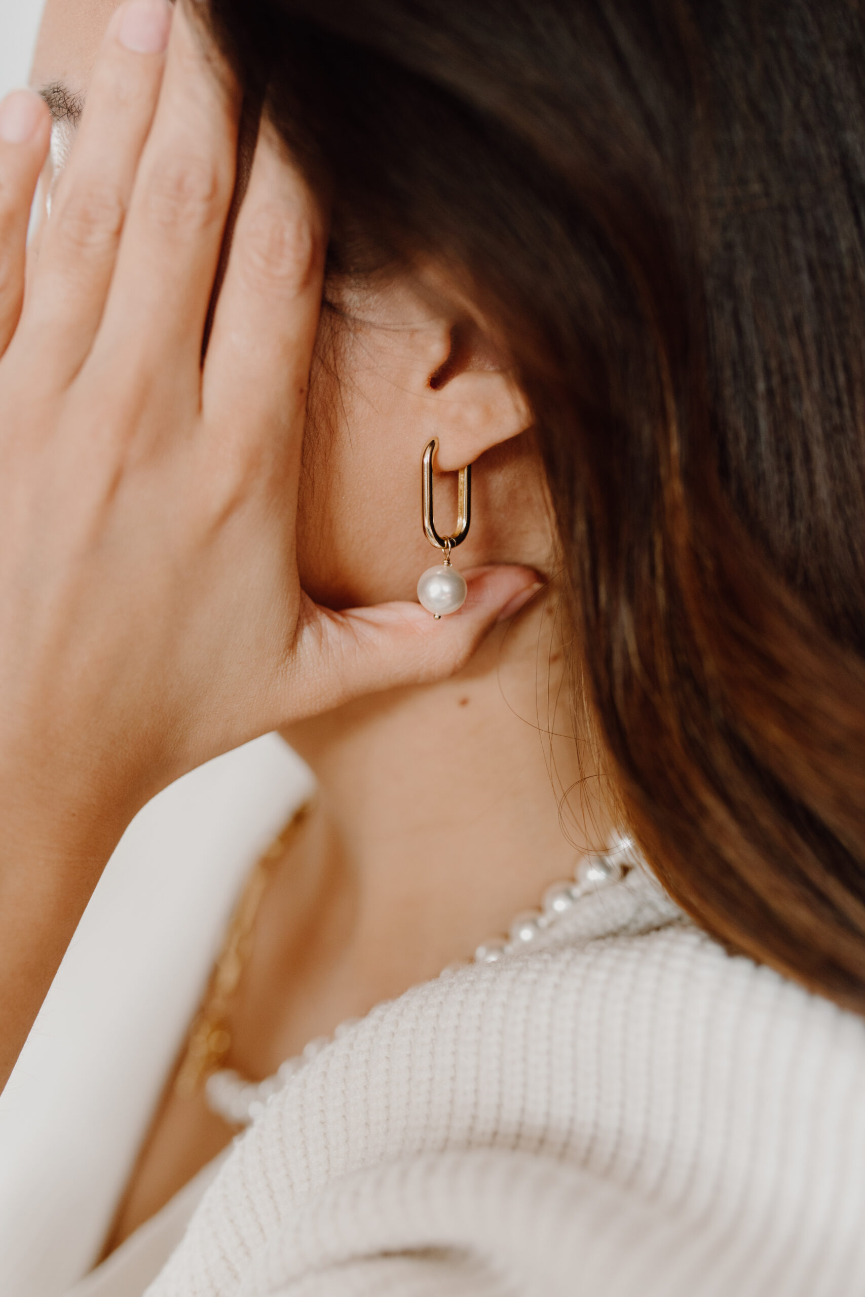 A guide to different types of earrings explaining the differences between studs, hoops, drops